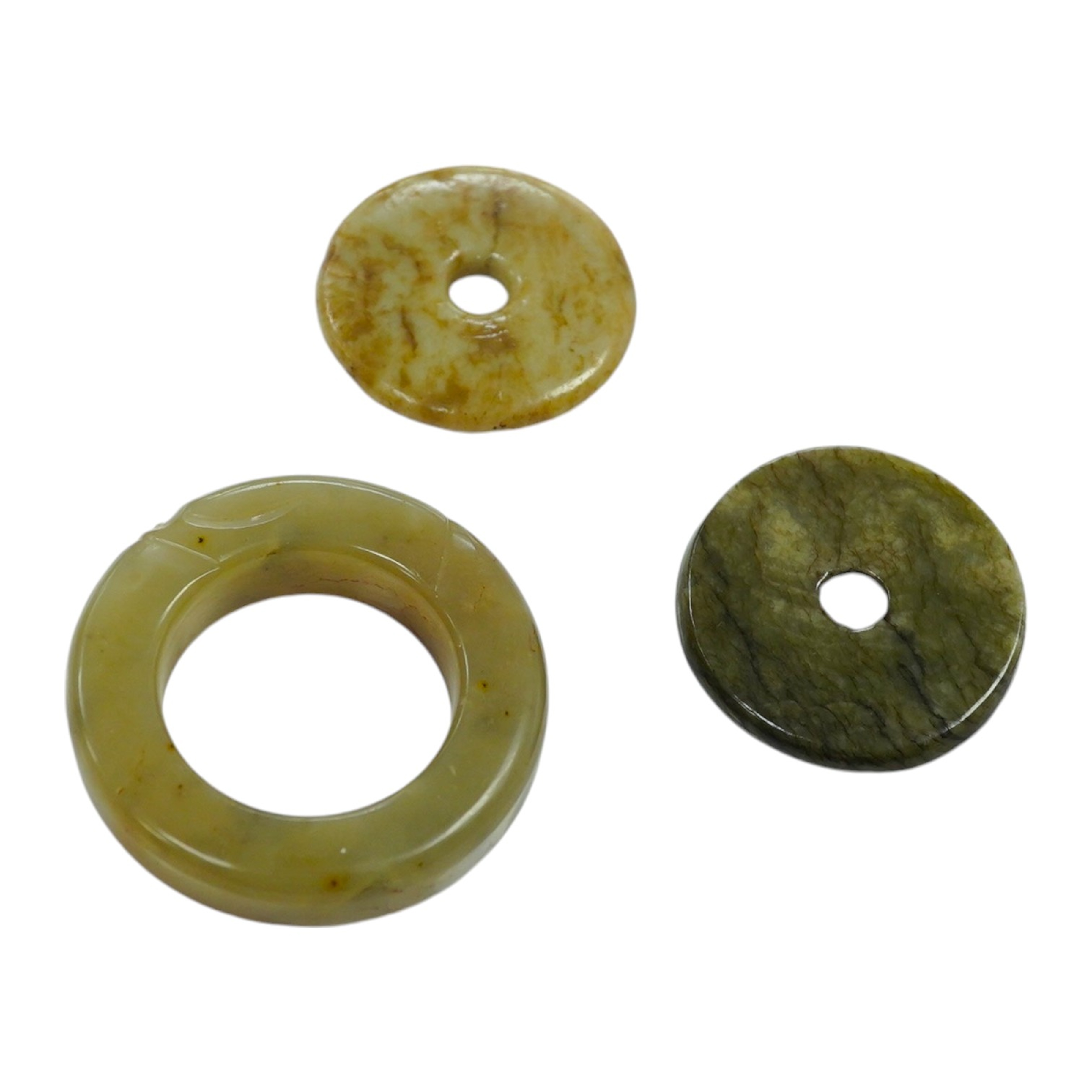 Two Chinese soapstone bi discs, and a jade ring, 18th century or earlier, largest 6.5cm in diameter. Condition - good